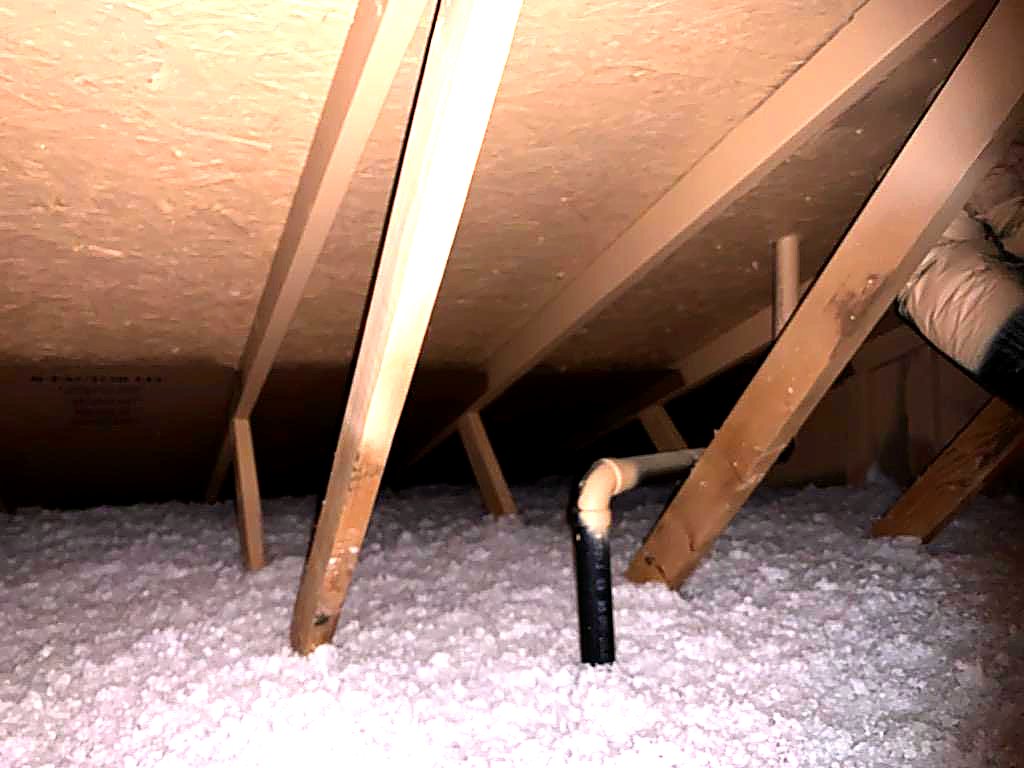 Loose-fill insulation around attic framing and vent stack