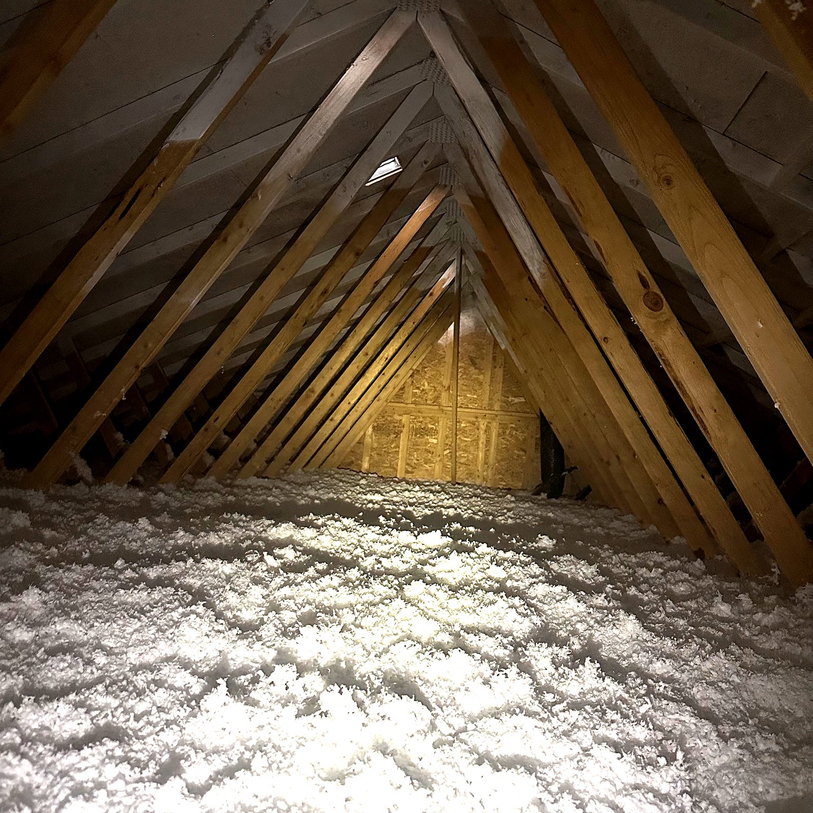 Deep blown-in insulation across an attic floor