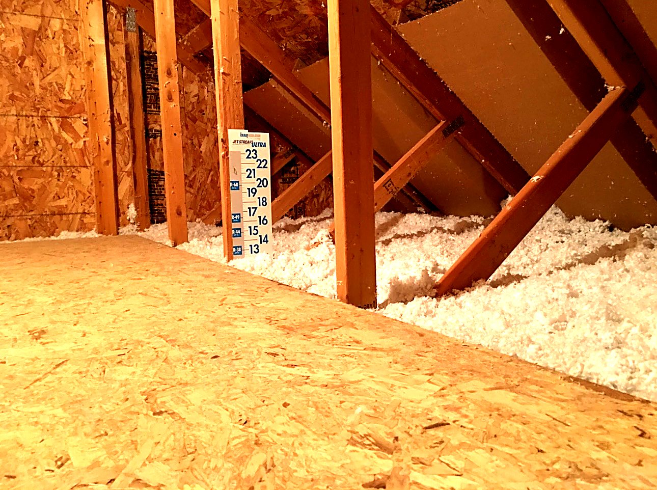 Blown-in attic insulation at a measured depth