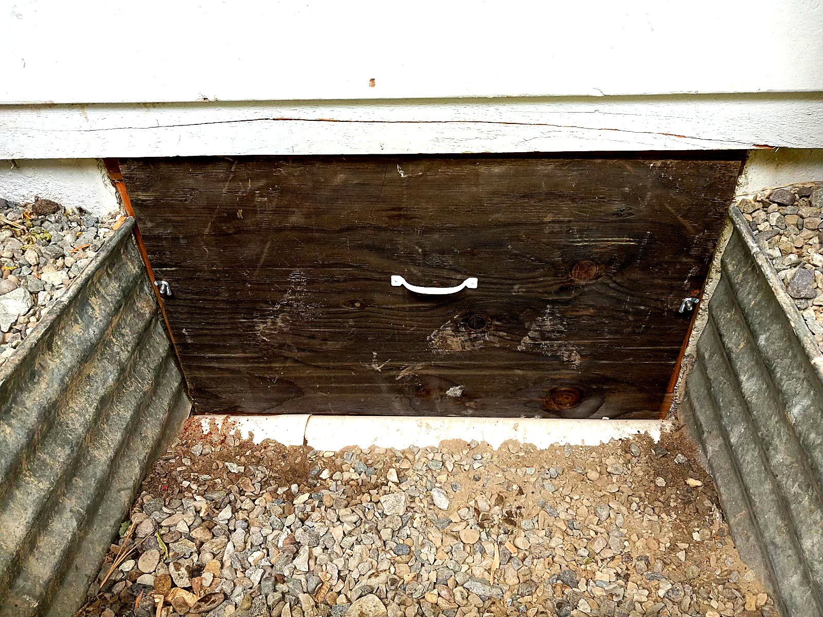 Crawl space access opening sealed and detailed