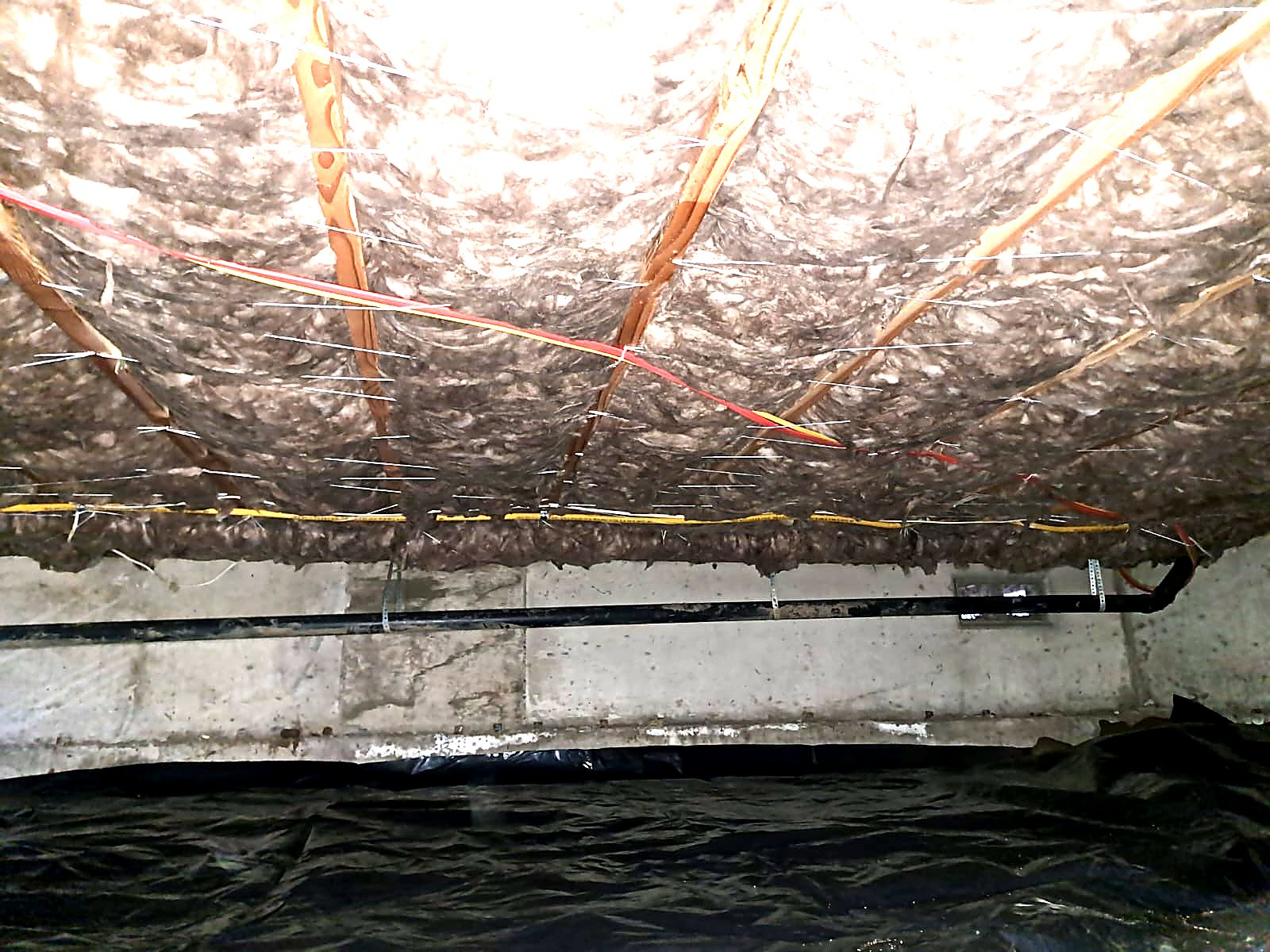 Deteriorated insulation ready for removal