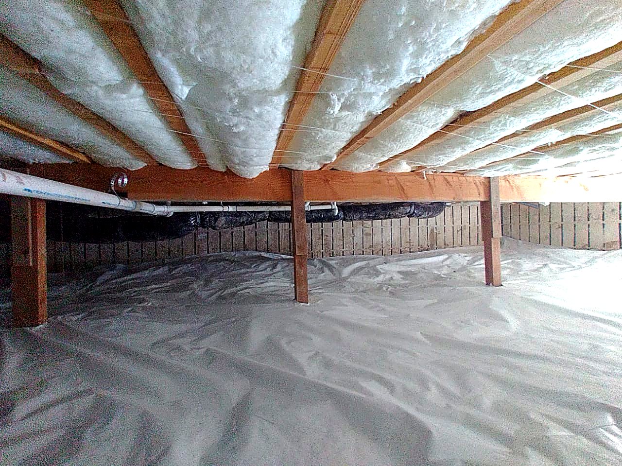 Completed crawl space insulation and ground cover