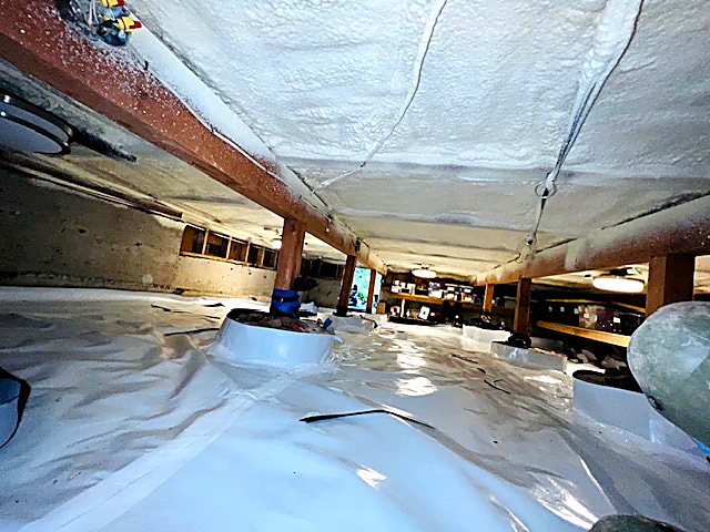 Vapor barrier being fitted around crawl space piers