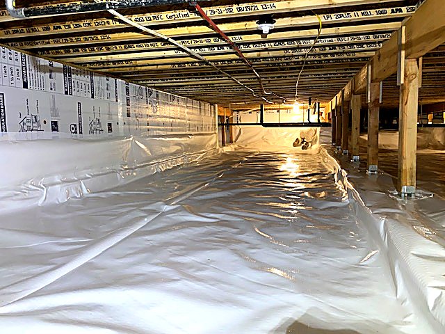 New vapor barrier laid across a full crawl space