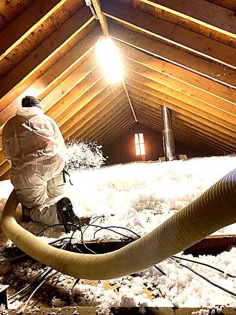 Blown-in insulation going into an attic
