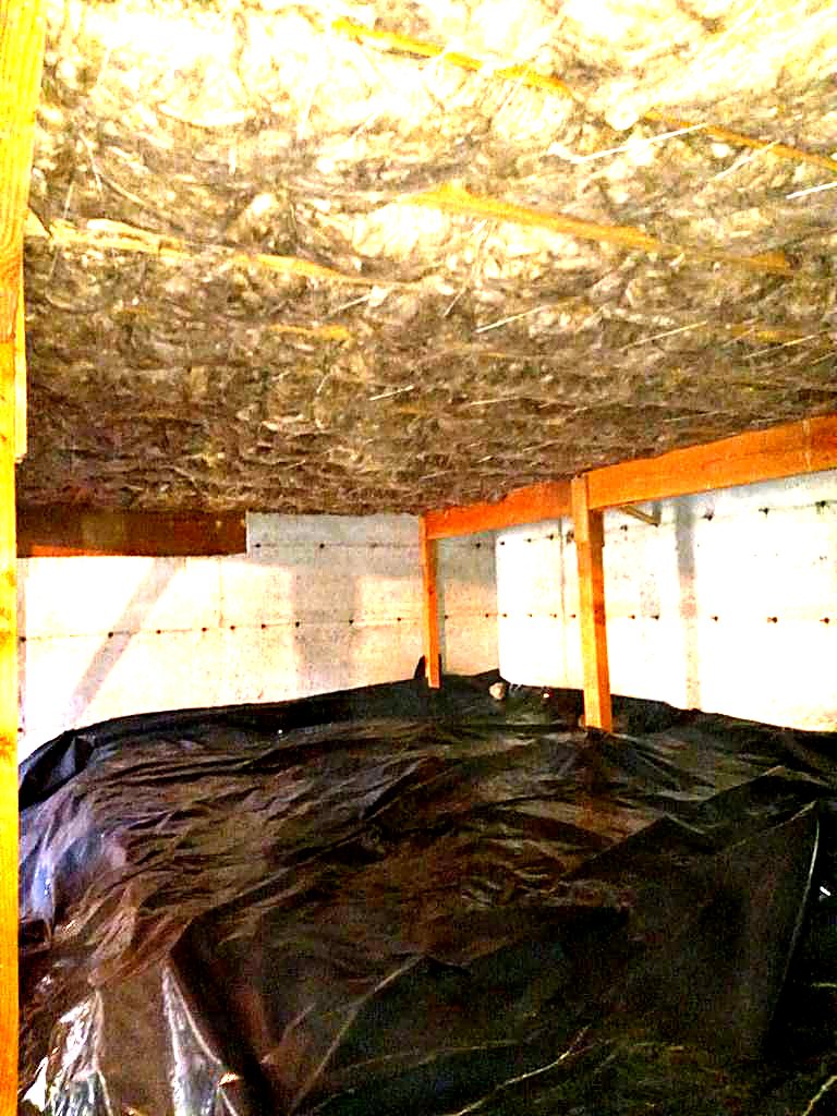 Attic insulation above a sealed ground barrier
