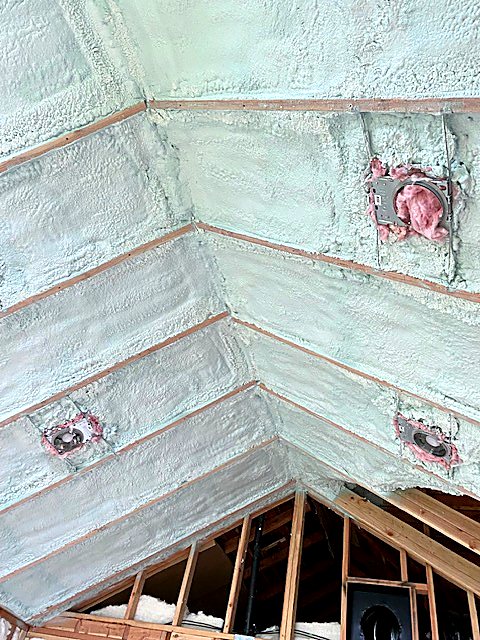 Spray-applied insulation in an attic knee wall