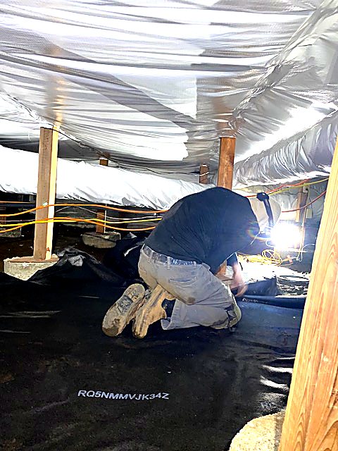 Installer fitting new crawl space insulation
