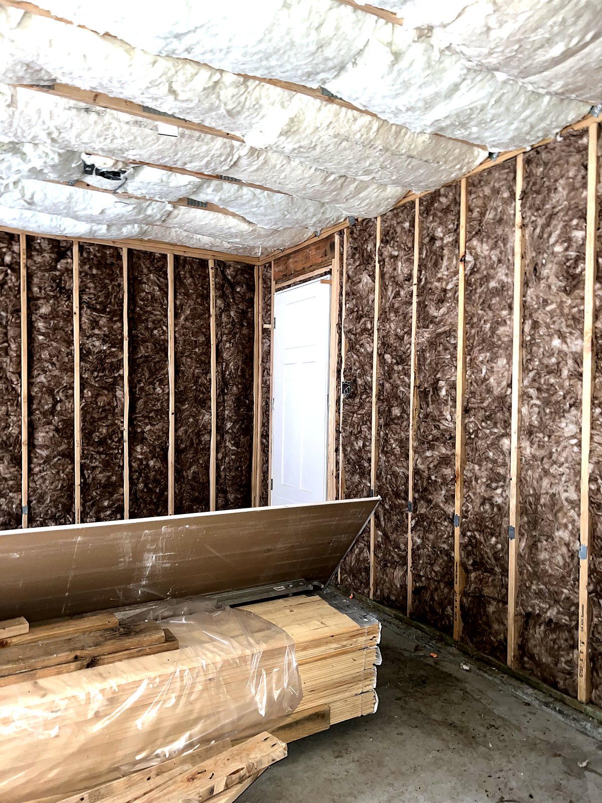 Wall cavities insulated ahead of drywall